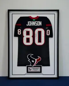 Framed Andre Johnson signed Houston Texans football jersey with display plaque.