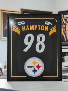 Framed Casey Hampton signed Pittsburgh Steelers football jersey with certificate of authenticity.