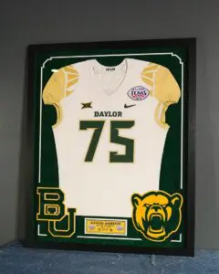 Green and gold college football jersey number 75 framed for display