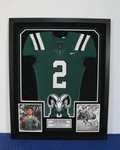 Green football jersey with Rams logo and number 2 framed for display
