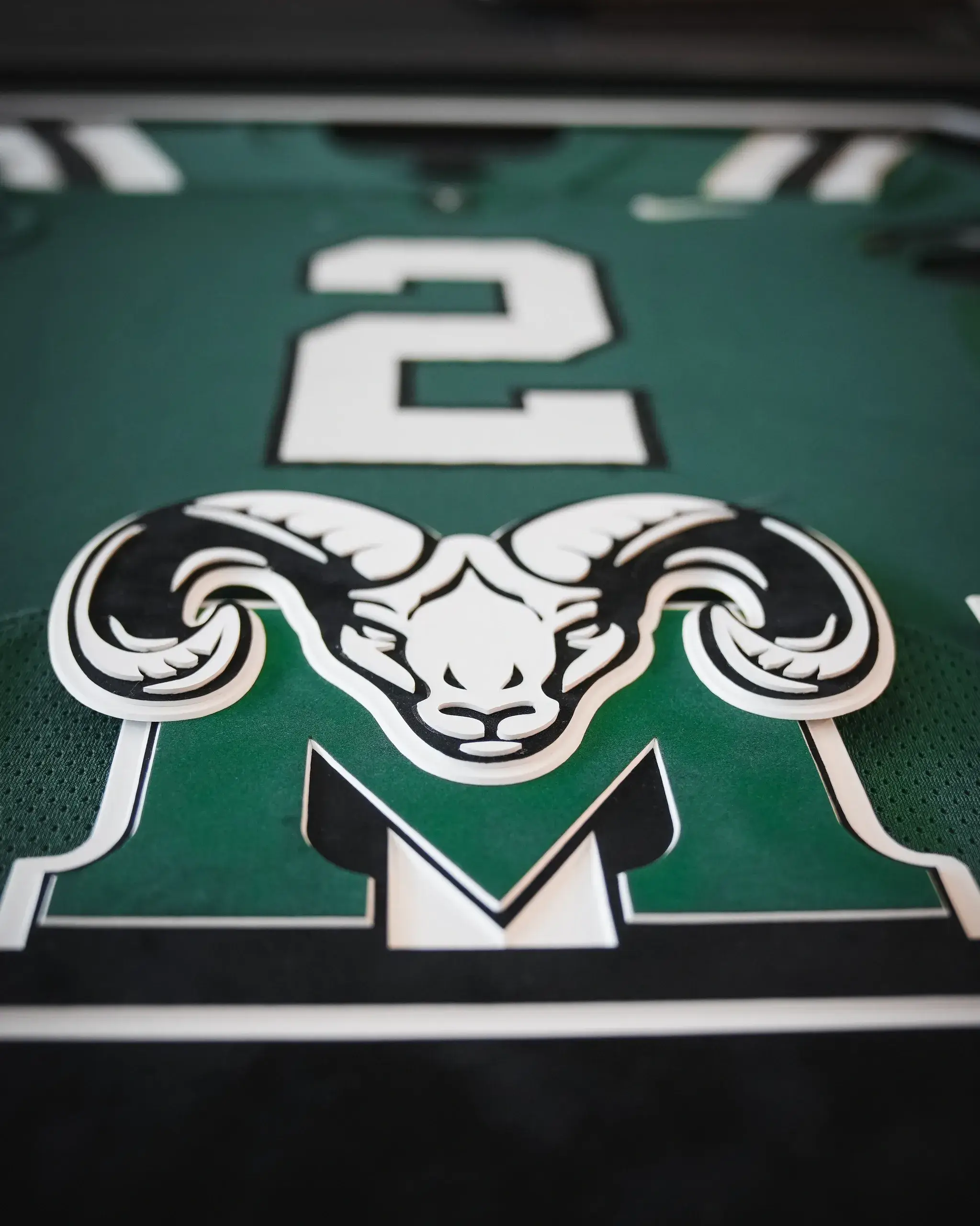 A close up of the number 2 and ram logo.