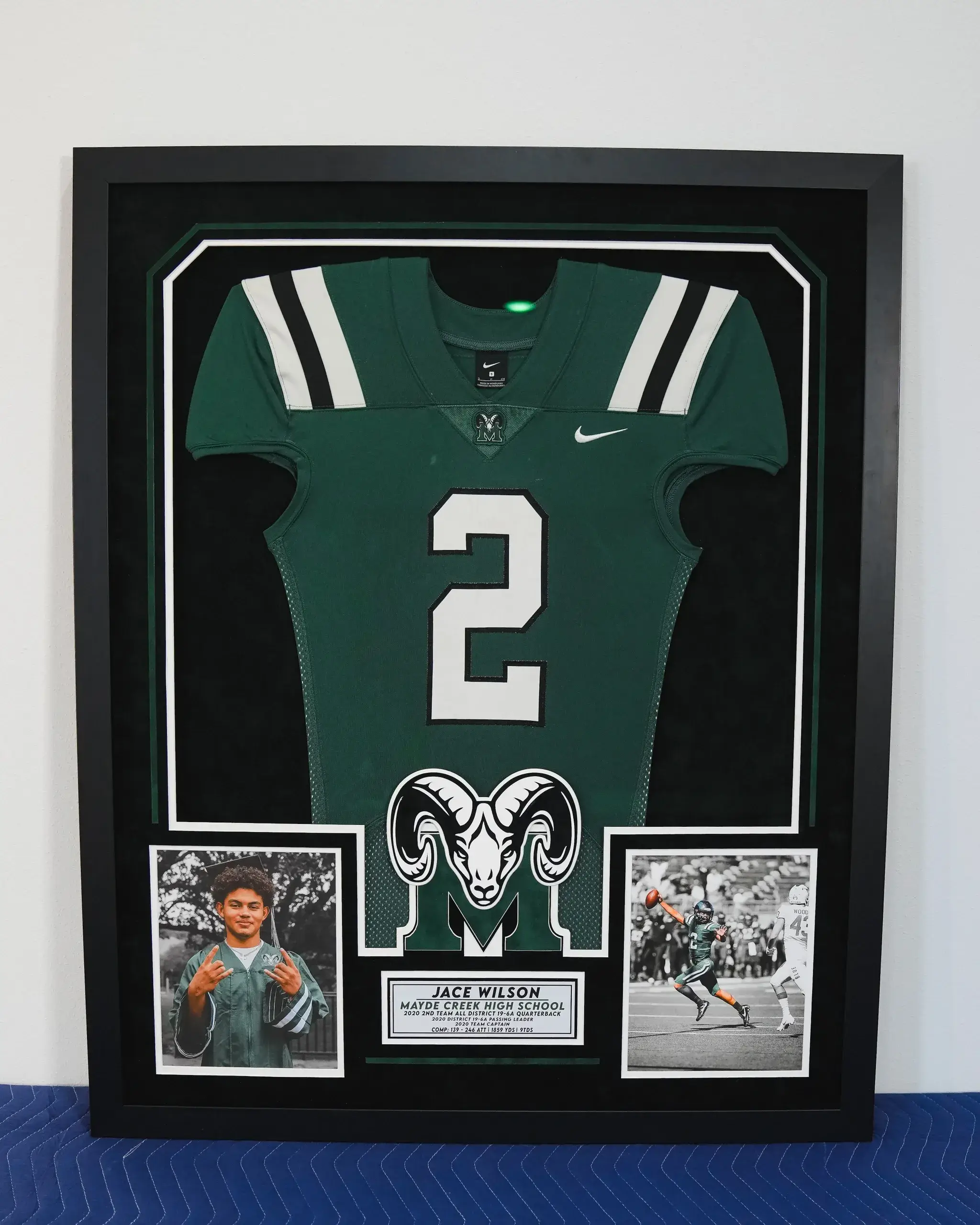 A framed jersey with photos and pictures of the rams