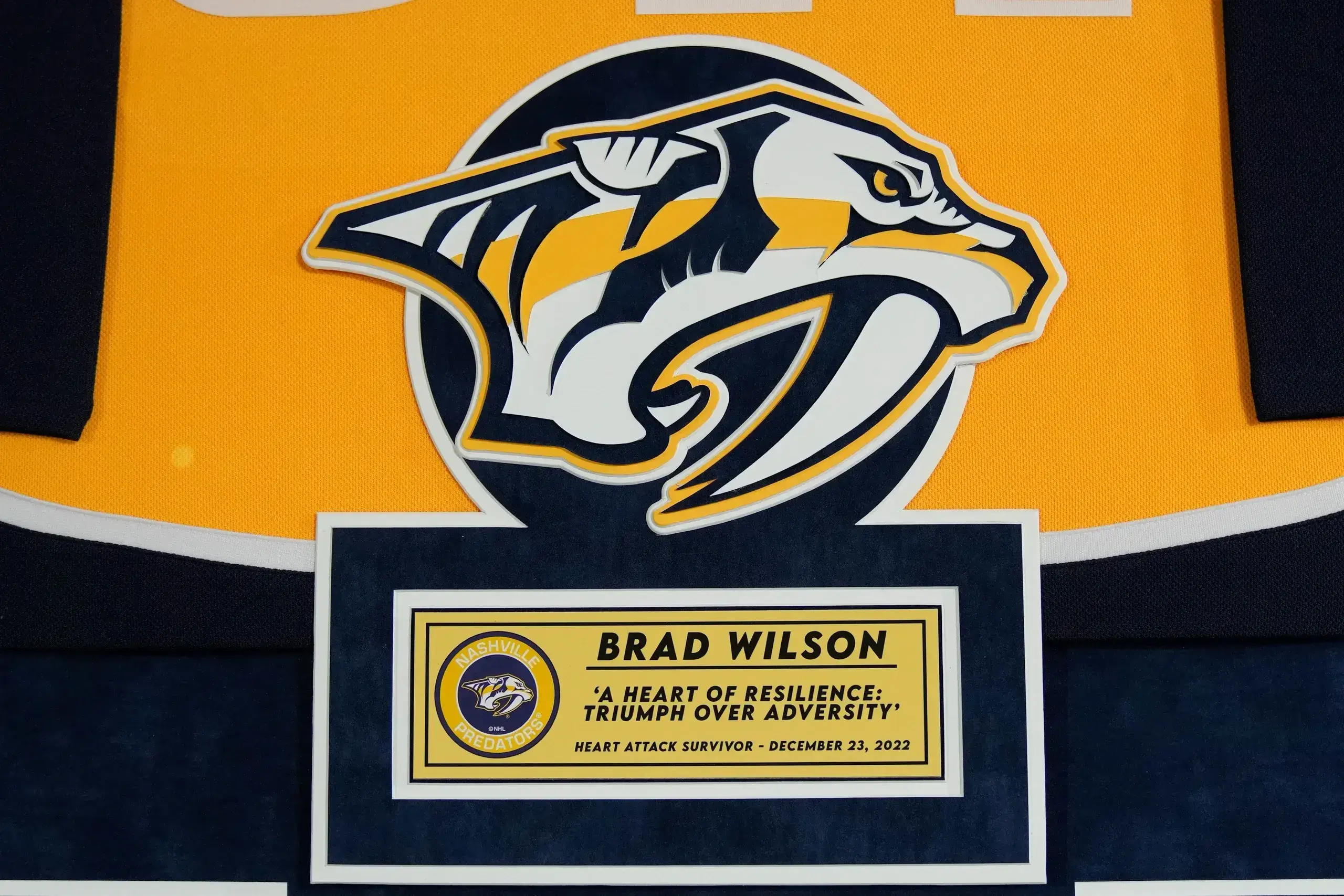 A plaque with the name of a player and logo.