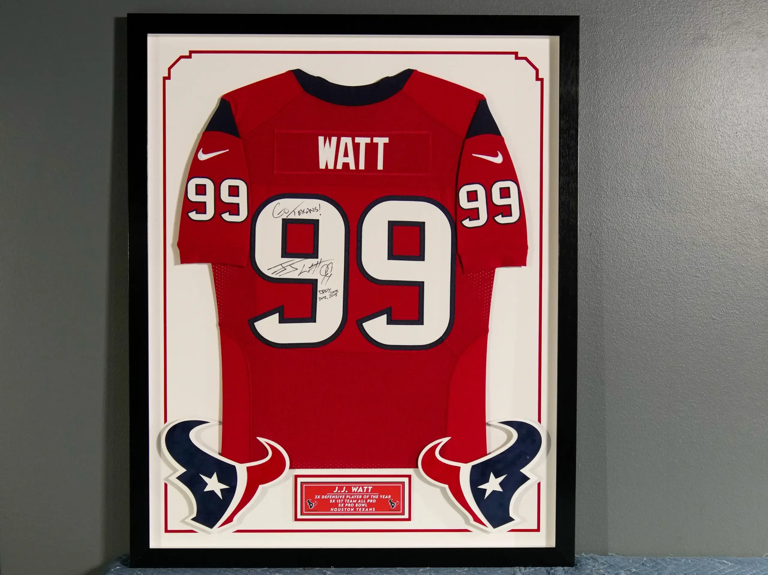 A framed jersey is displayed in the hallway.
