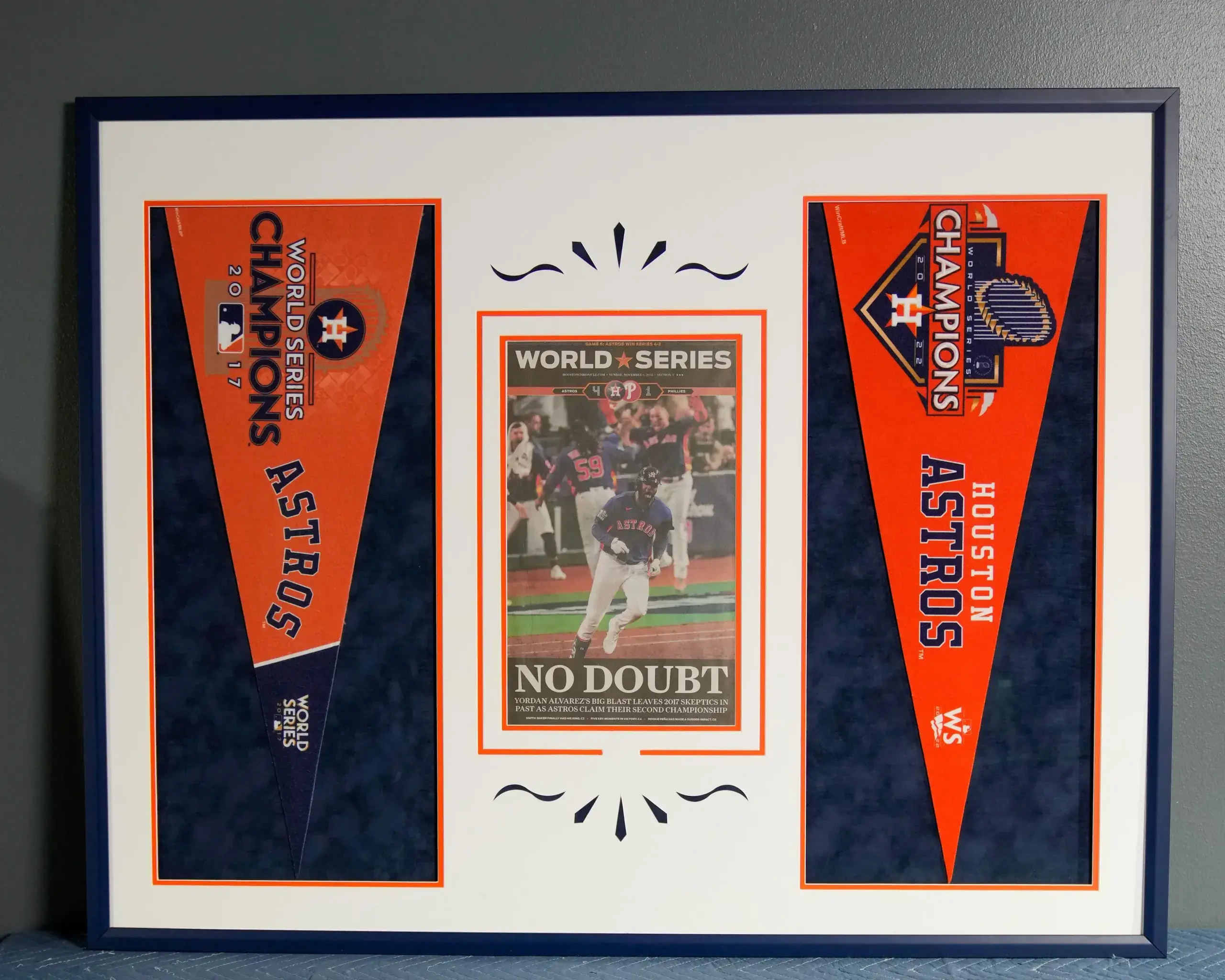 A framed picture of the astros and their pennant.
