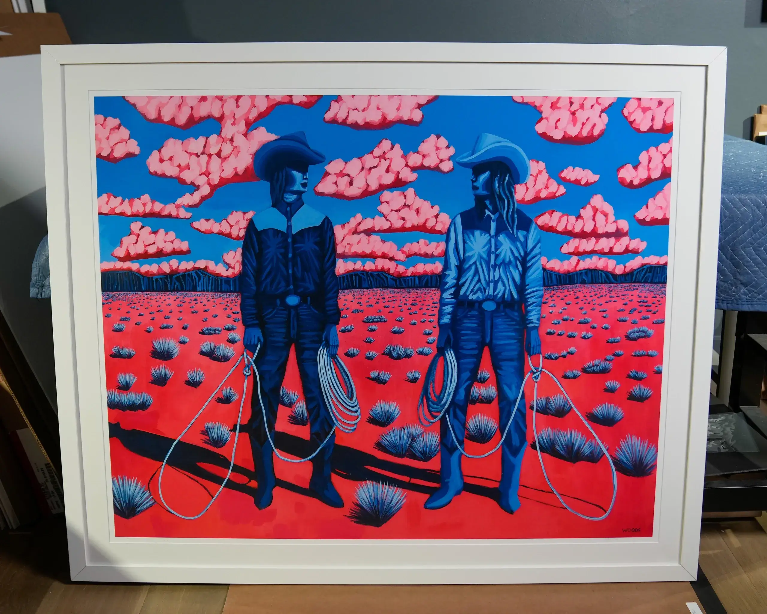 A painting of two men holding lasso in the desert.