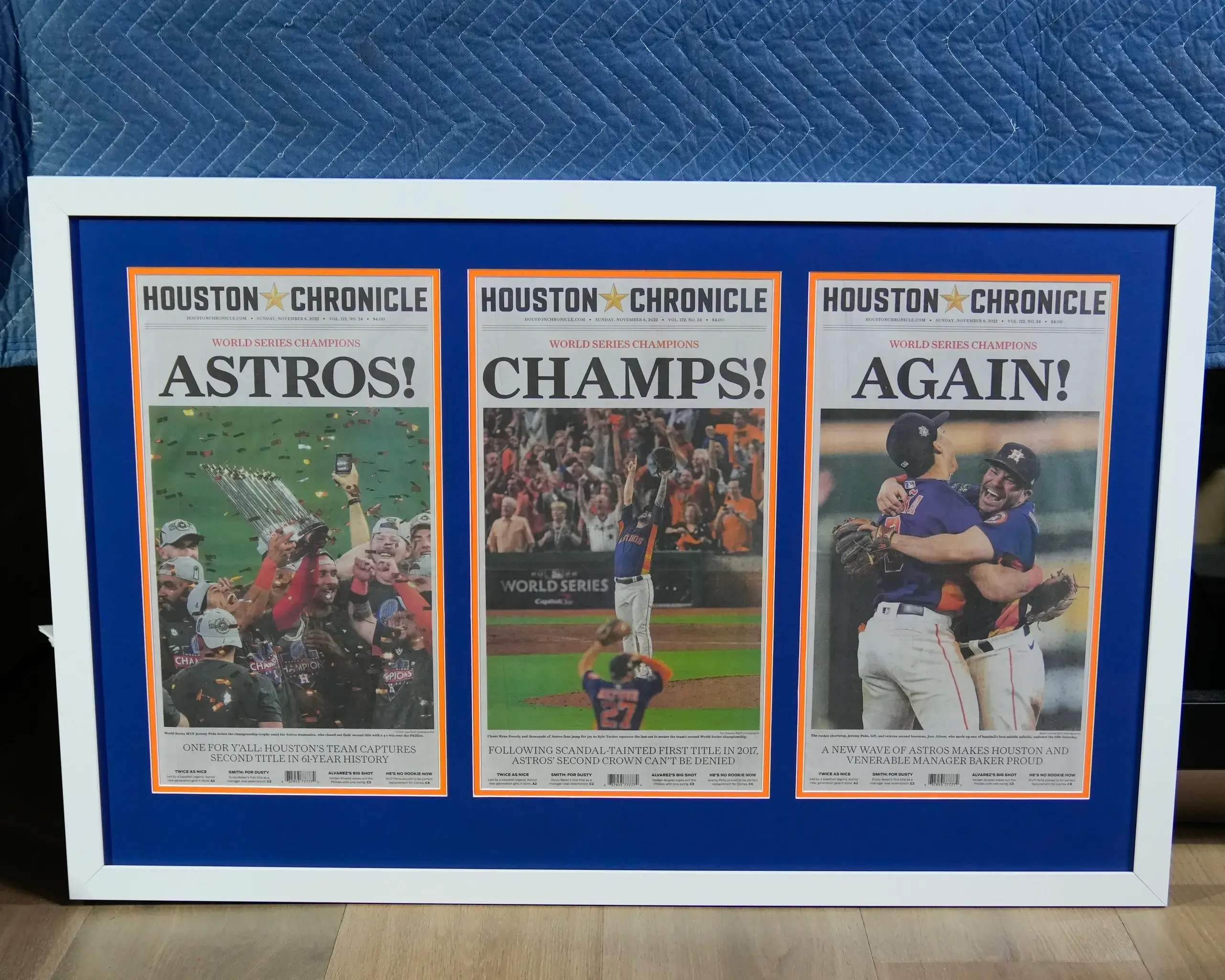 A framed newspaper with the astros ' baseball team 's posters.