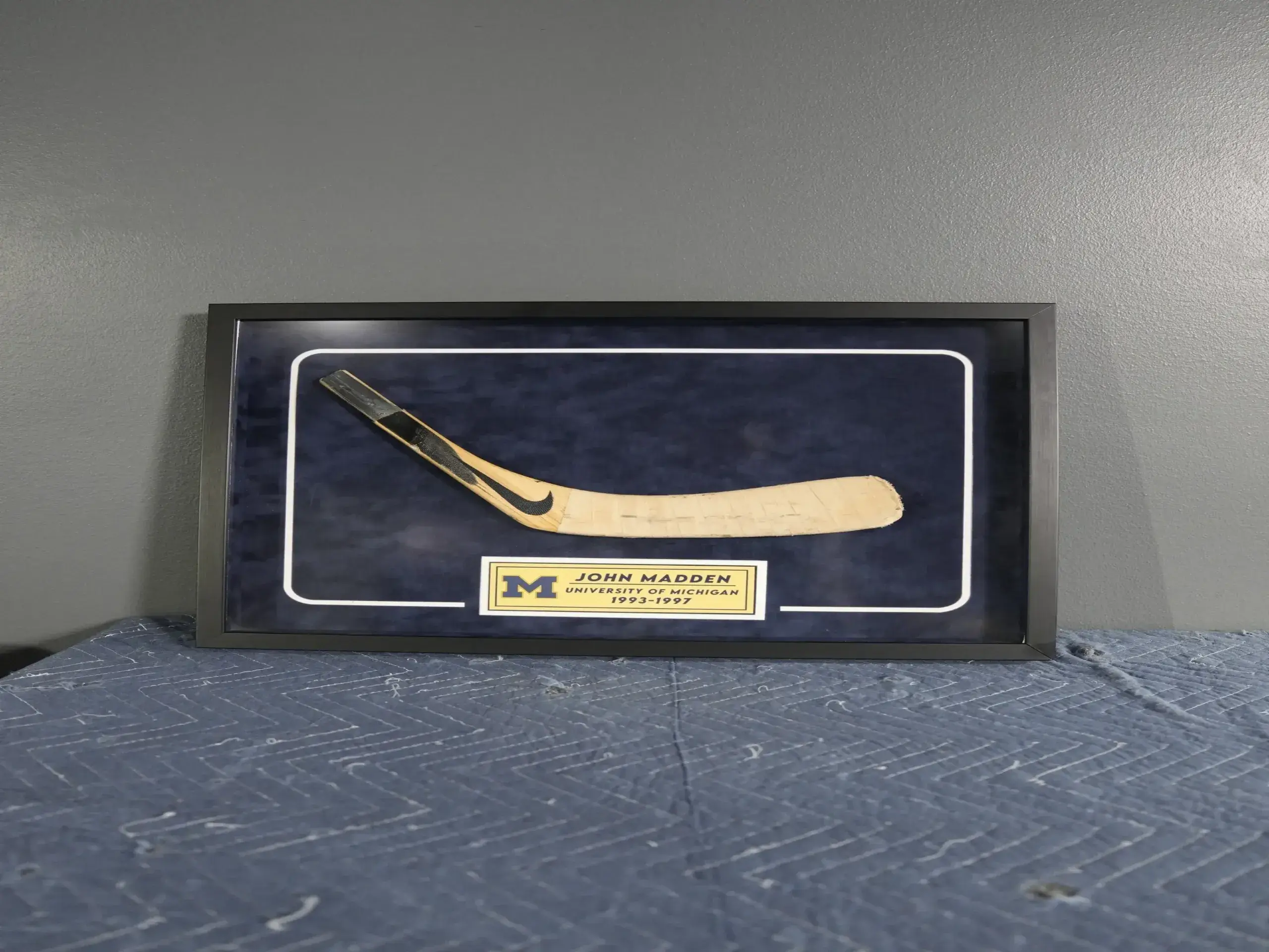 A hockey stick is displayed on the wall.