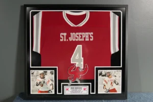 Baseball jersey displayed in custom shadow box frame with memorabilia