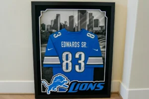 Blue football jersey number 83 framed in sports shadow box