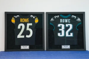 Teal and white football jerseys numbered 25 and 32 framed together