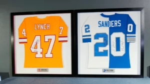 White and blue football jerseys numbered 47 and 20 framed together