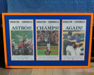 a frame newspaper, with astros, champs and again on it
