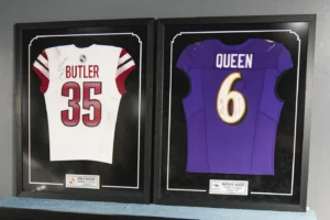Custom sports memorabilia shadow box featuring jerseys and photos